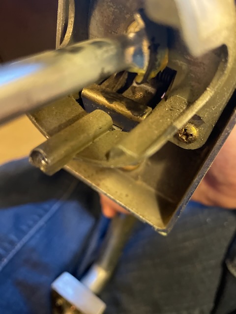 A closeup of the inside of a door handle, where the worn section missing metal is causing the problem with the door lever actuating the latch.